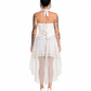 A woman modeling a white two-piece outfit consisting of a halter crop top with ruffle trim and a matching high-low tulle skirt with lace detailing