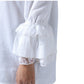 White long-sleeve blouse with a textured waffle fabric, elasticized gathered waist, and layered ruffled sleeves finished with lace trim, shown on a model against a white background.