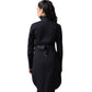 A woman shown from the back wearing a long black coat with a matching black belt and silver-tone studs, photographed against a plain white studio background.
