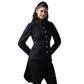 A woman modeling a black long-sleeve high-collar jacket with decorative ruffles and silver buttons, paired with black trousers, against a plain white background.