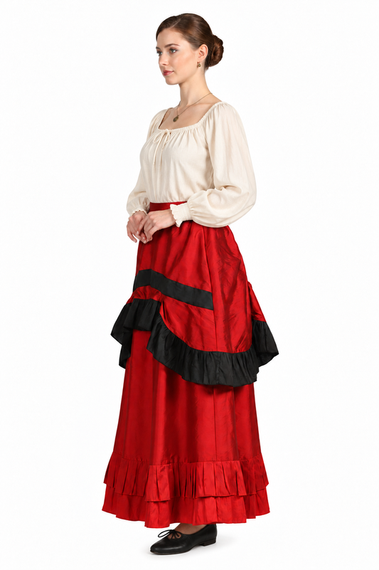 A woman modeling a traditional Spanish-style dress with a cream-colored long-sleeve blouse and a voluminous red skirt featuring black ruffle accents, set against a plain white background.