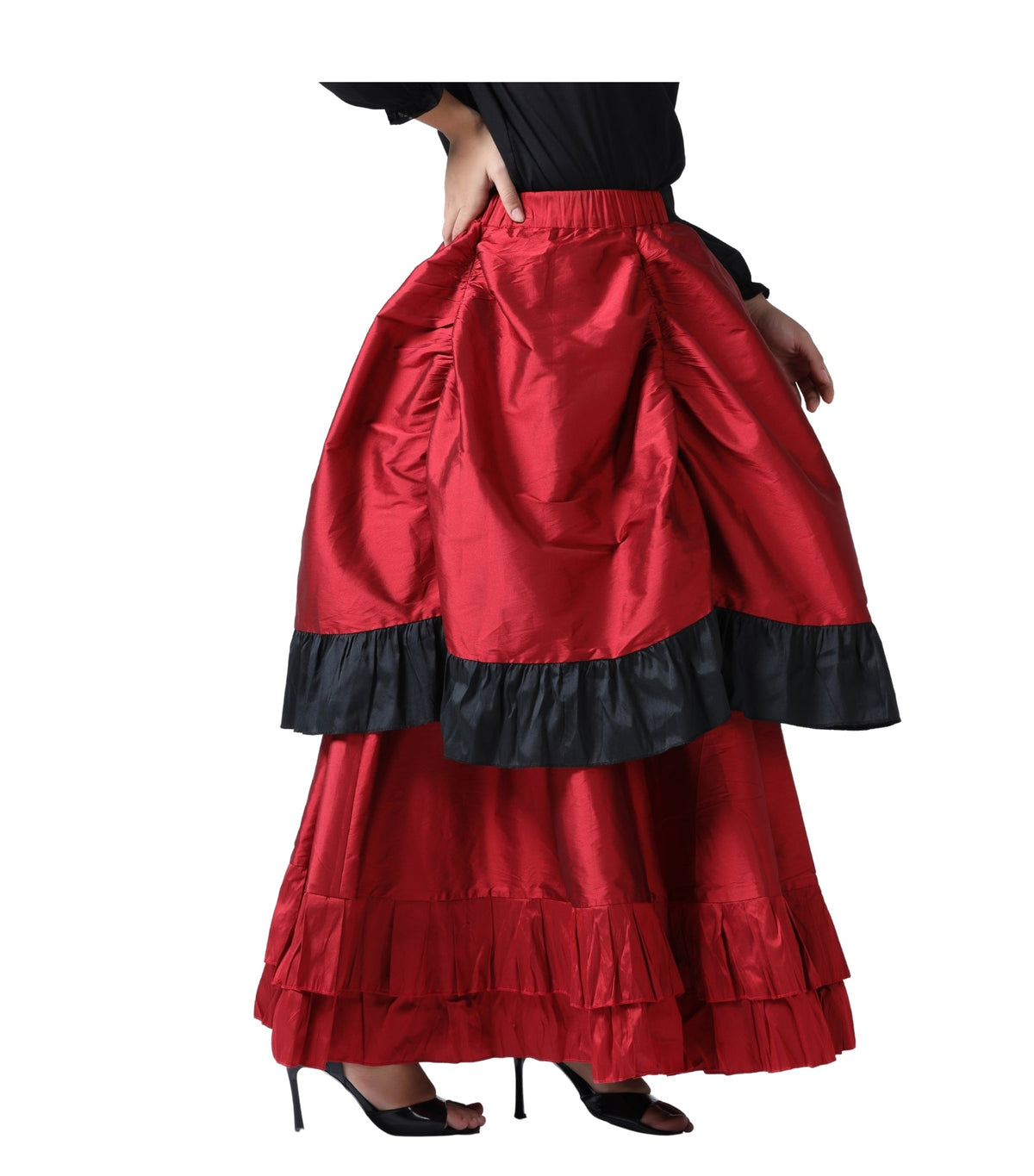 Side view of a model wearing a red and black ruffled high-low Steampunk bustle skirt with an ivory peasant blouse.