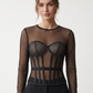 Black polka dot mesh corset top with long sheer sleeves, a round neckline, shaped cups and defined boning channels.