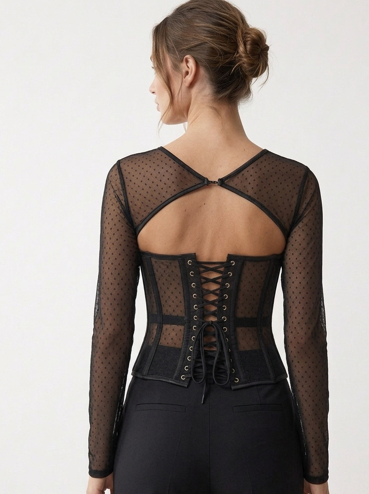  Back view of black dotted mesh corset top with a curved cut-out, upper fastening and adjustable black lacing.