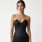 Black strapless floral lace overbust corset with satin panel detailing, shaped bust cups and a scalloped eyelash-lace hem.