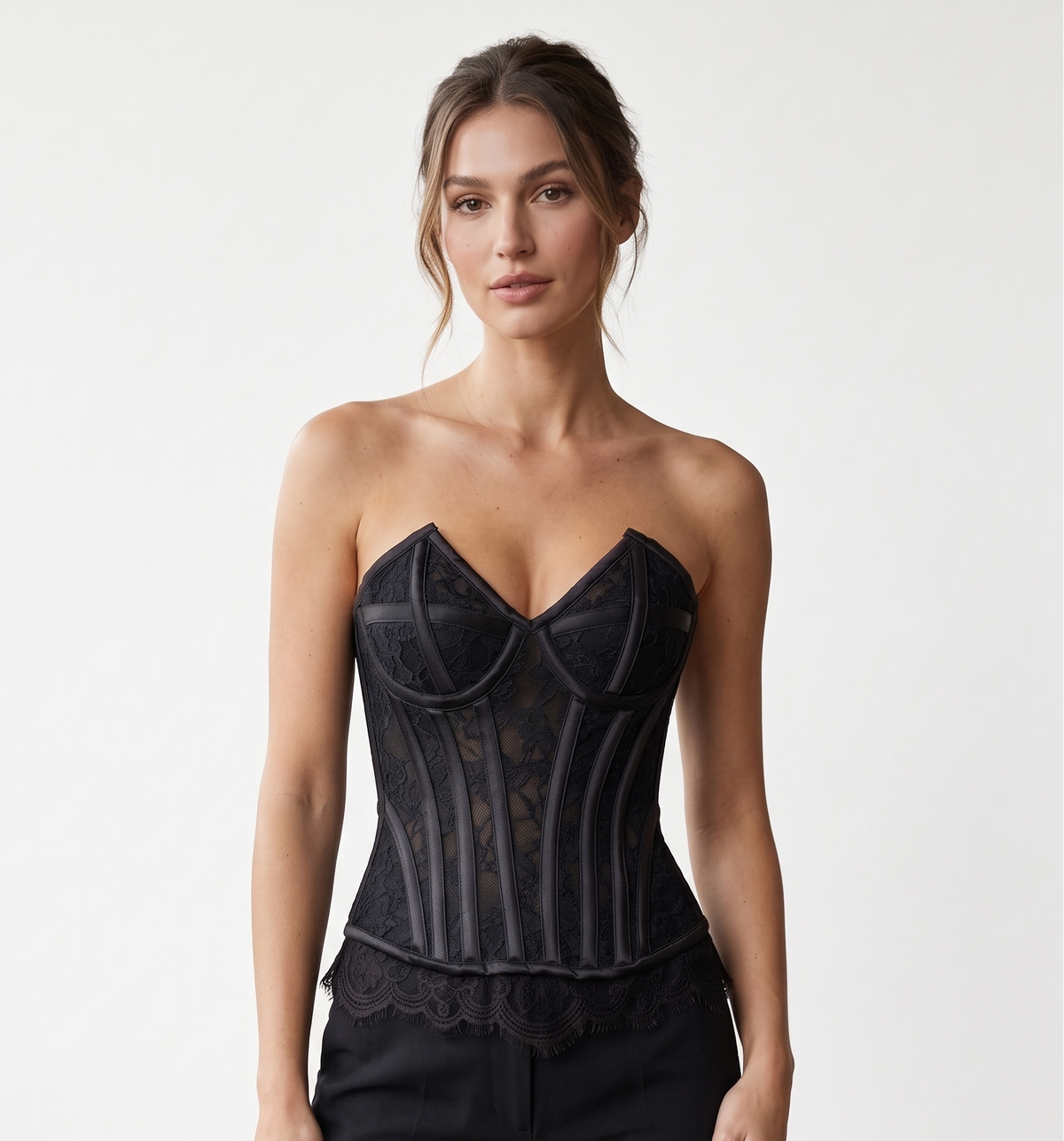 Black strapless floral lace overbust corset with satin panel detailing, shaped bust cups and a scalloped eyelash-lace hem.