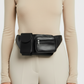 a girl has wholesale black waist bag on a white background